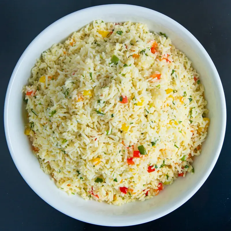 A bowl of garden fried rice with peppers and herbs