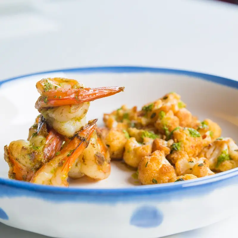 Pepper shrimp with roasted cauliflower and herb oil