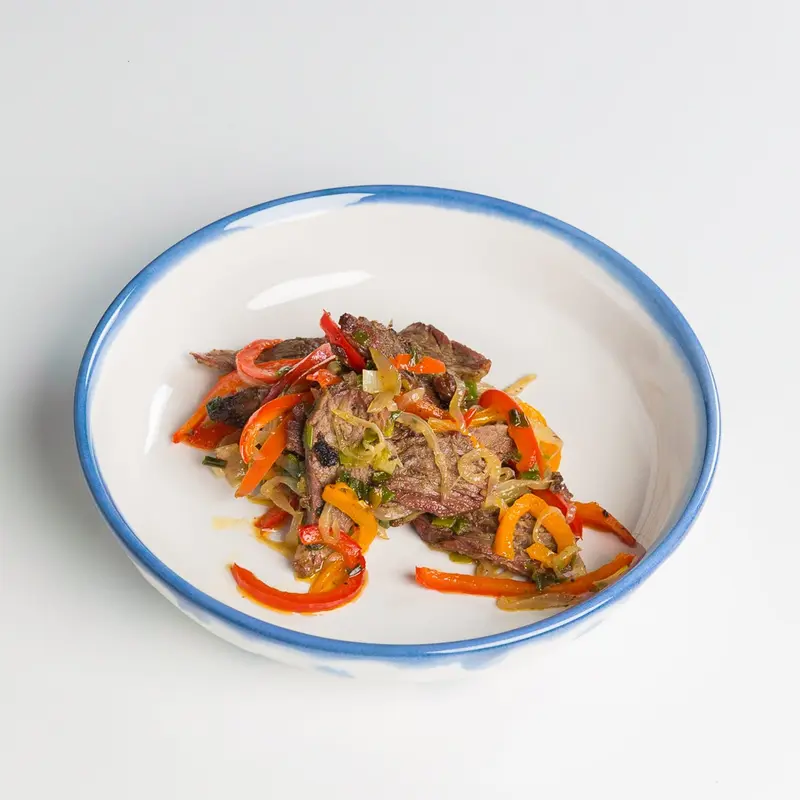 Suya beef with peppers in a bowl